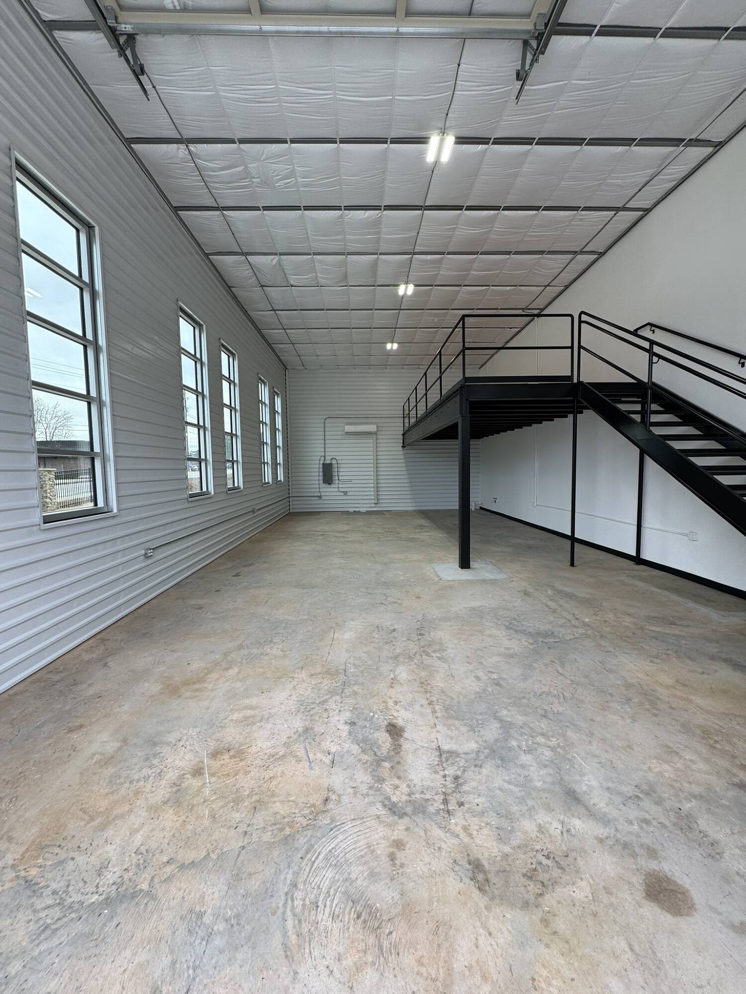 Spacious flex unit interior with high ceilings and mezzanine at Carrollton Flex Park